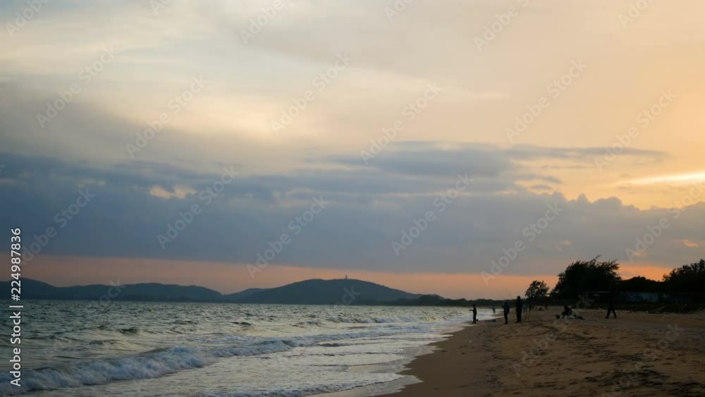 The silhouettes of people are fishing at the beach in the evening and the mountains with twilight sparkle The silhouettes of people are fishing at the beach in the evening and the mountains with twilight sparkle