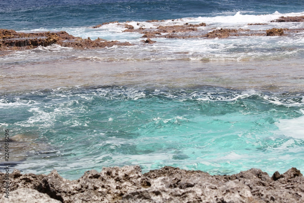 Different hues of clear blue waters at a beach in a tropical island Different hues of clear blue waters at a beach in a tropical island