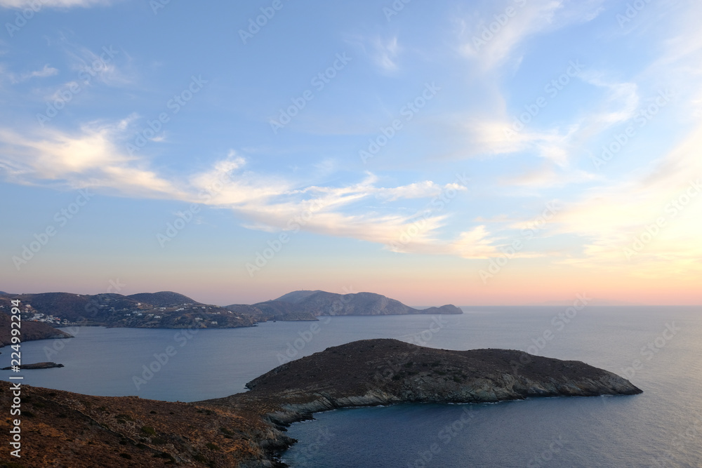 Island of Syros in greece, panorama of  cliff close to Varvarousa beach with sand land and sea. Sunset.