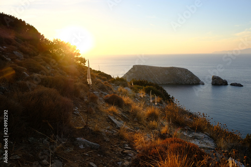 Island of Syros in greece, panorama of cliff close to Varvarousa beach with sand land and sea. Sunset.