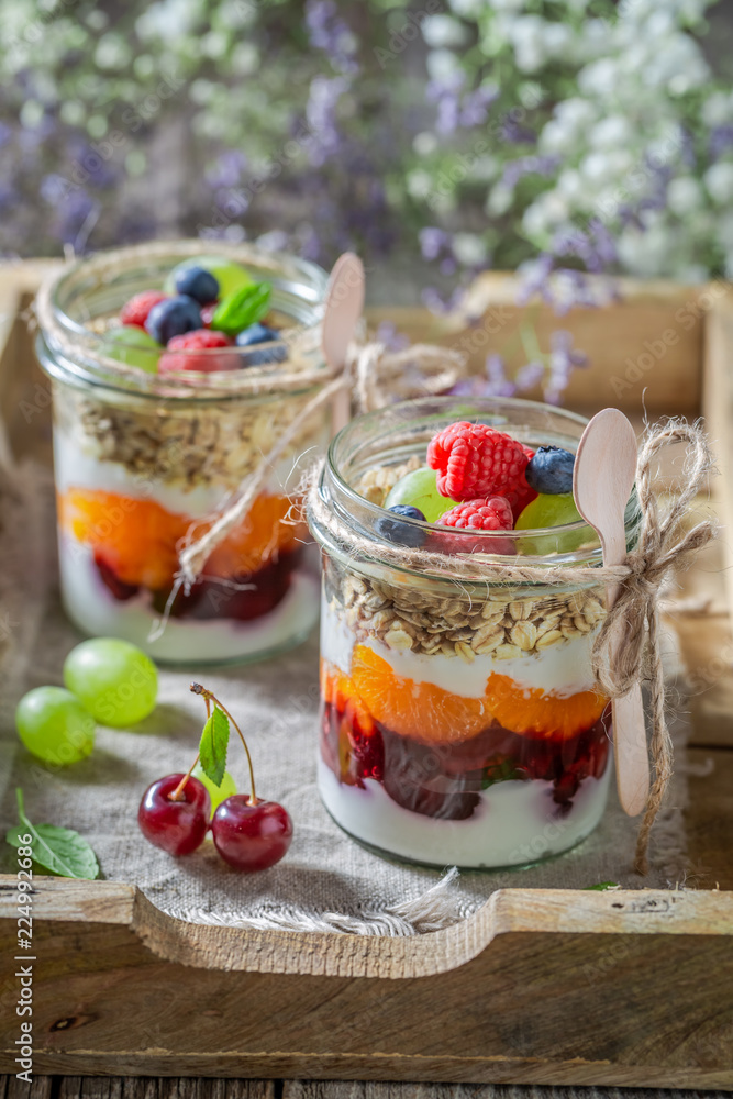 Delicious oat flakes with fresh fruits and yoghurt in jar Delicious oat flakes with fresh fruits and yoghurt in jar