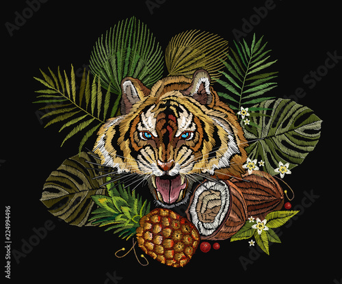 Fototapeta Naklejka Na Ścianę i Meble -  Embroidery tiger in the jungle, palm tree leaves, pineapple, coconut tropical art. Fashionable template for clothes, t-shirt design. Embroidery angry tiger face