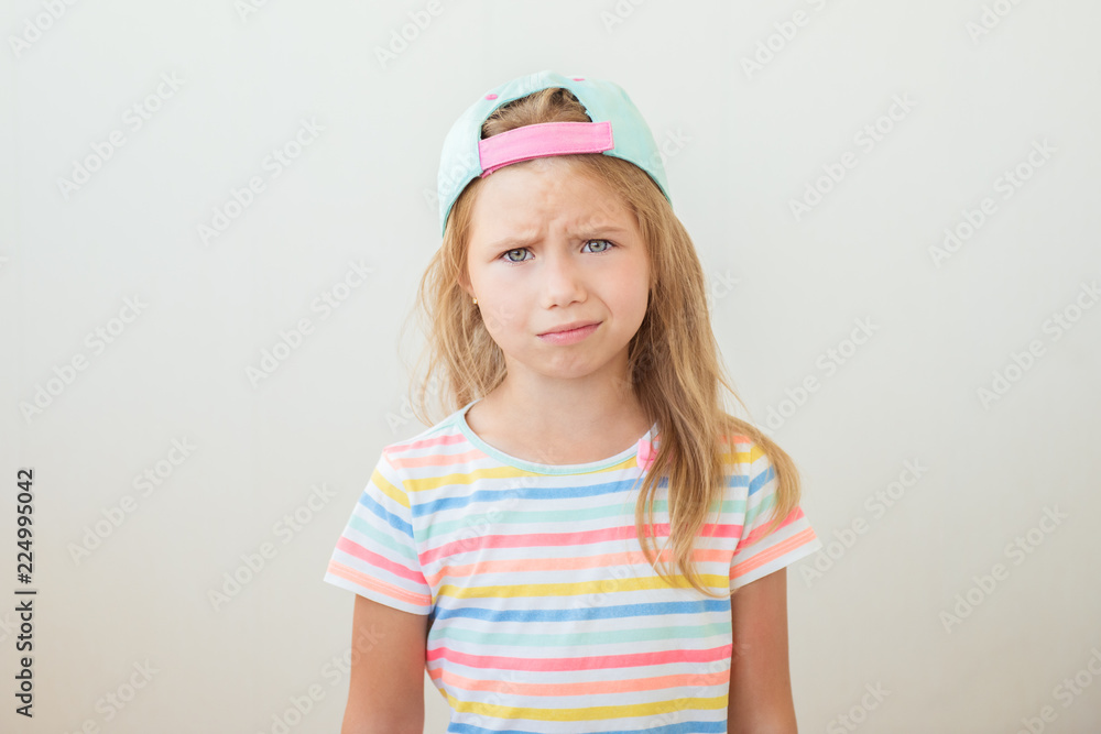 Frustrated beautiful little girl on white background
