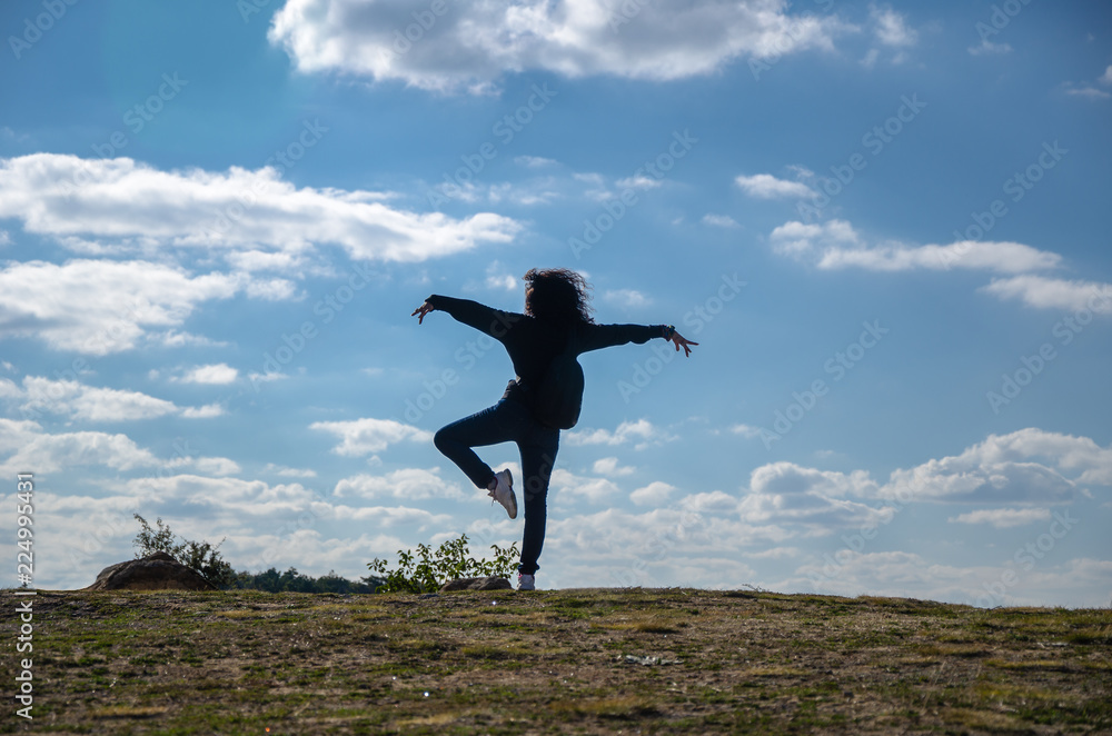 Beautiful young woman is standing silhouette.