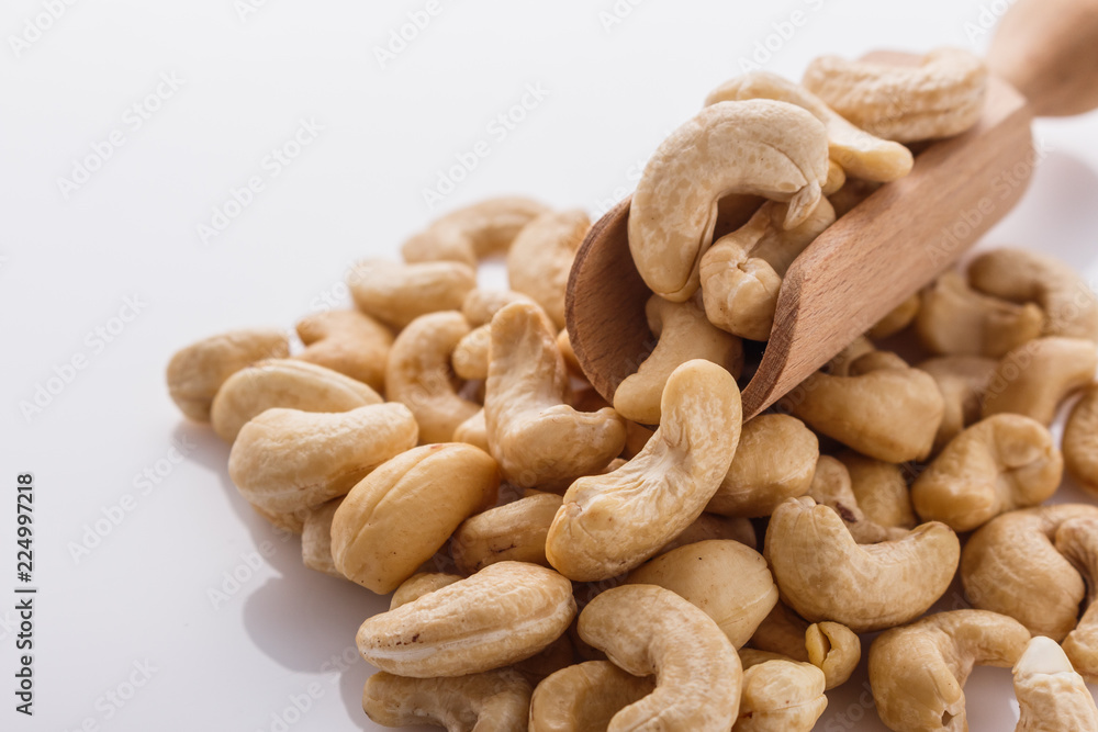 cashew nuts on a white acrylic background cashew nuts on a white acrylic background