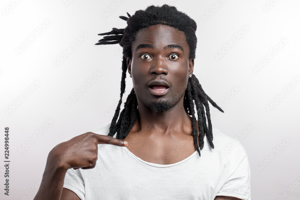 Who, me dark skinned male with dreadlocks looking at camera pointing at ...