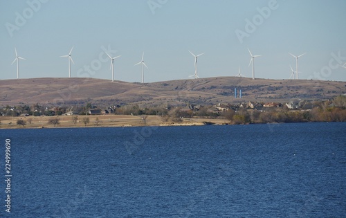 Lake Lawtonka in Lawton, Oklahoma with a row of windmills in the distance © raksyBH