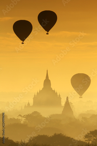 Silhouette of the Tourist Balloon fly over pagoda in the morning on Bagan, Myanmar. Balloon flying is very popular for tourists for pagoda sightseeing