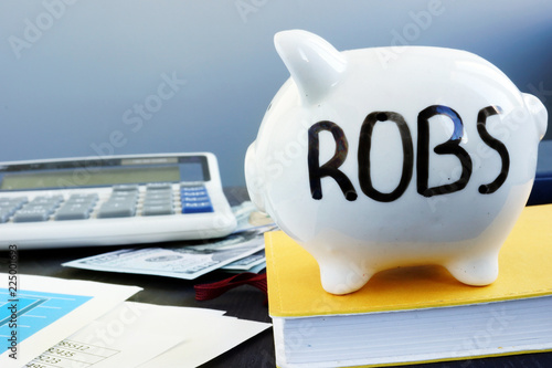 Schilderij op canvas Rollover for Business Startups ROBS written on a piggy bank.