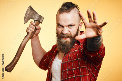 Konstfotografi Furious agressive lumberjack. bearded man swinging with axe
