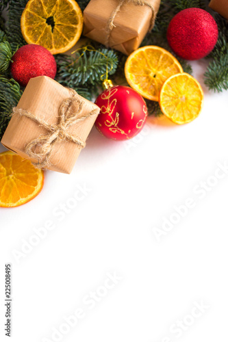 Christmas and New Year border design on the white background with fir tree and orange dry decoration and space for text

