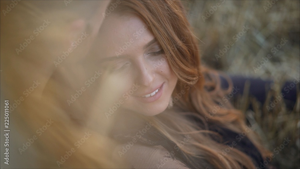 A man is holding a woman in his arms. Smiling couple front view. A girl in the arms smiles in the arms of a guy. A man is holding a woman in his arms. Smiling couple front view. A girl in the arms smiles in the arms of a guy.