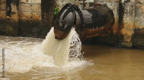 Wallpaper Mural Flood control .
Hugh amount of rain water flowing through metallic flap gate to a river,hd slow motion.
 Torontodigital.ca