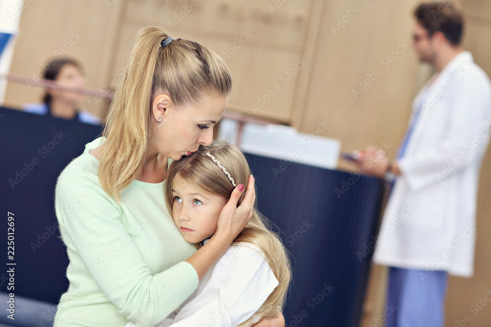 Little girl is crying while with her mother at a doctor on consultation