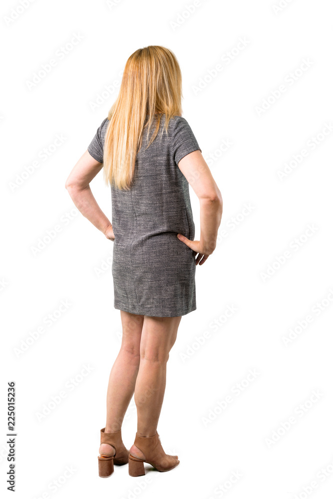 Middle age blonde woman with grey dress looking back on isolated white background. Ideal for use in architectural designs Middle age blonde woman with grey dress looking back on isolated white background. Ideal for use in architectural designs