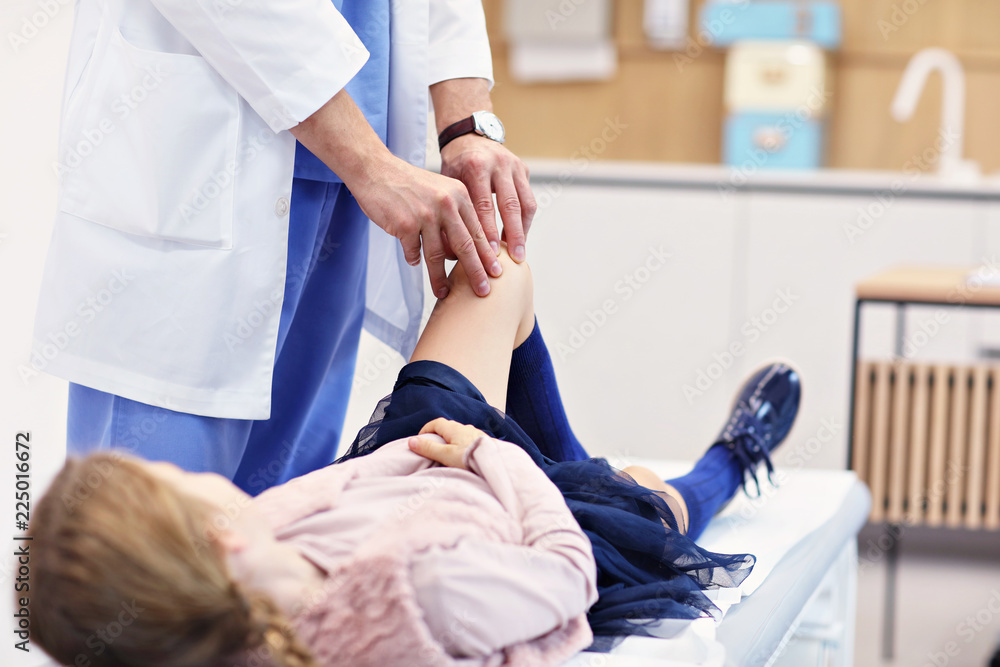 Little girl in clinic having a checkup with orthopaedist Little girl in clinic having a checkup with orthopaedist