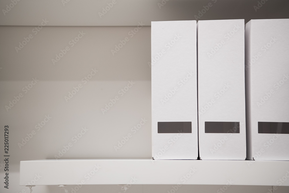 White magazine files on a shelf at home office White magazine files on a shelf at home office