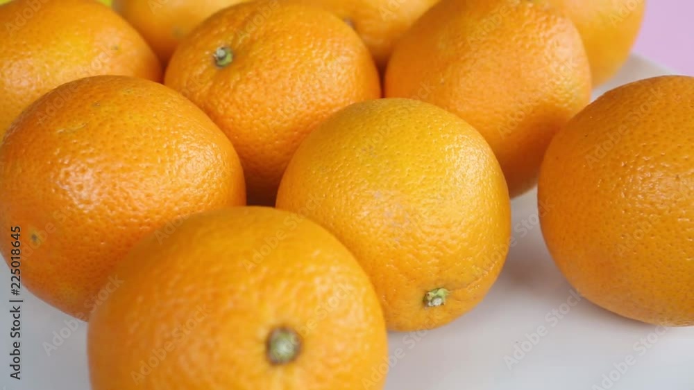 group of oranges on a white rotating plate
group of oranges on a white rotating plate