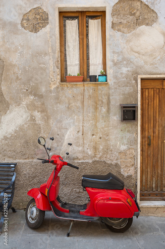 Red scooter parked in Pitigliano, Tuscany