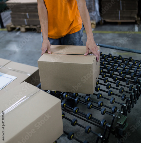 Close up shot of worker's hand preparing carton for printing in a modern printing house.