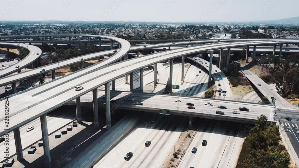 Drone flying around majestic Judge Pregerson highway road interchange in Los Angeles, USA with cars on multiple levels. Drone flying around majestic Judge Pregerson highway road interchange in Los Angeles, USA with cars on multiple levels.