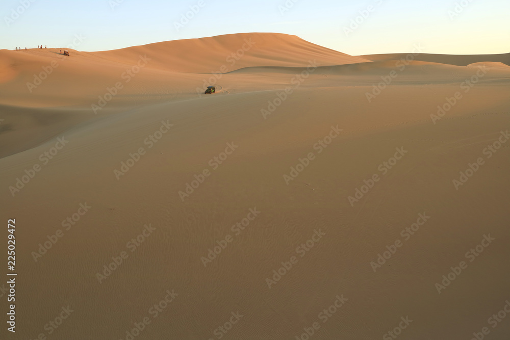 People enjoy dune buggy on the immense desert of Huacachina, Ica, Peru, South America