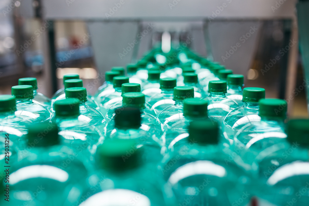 Industrial factory indoors and machinery. Robotic factory line for processing and bottling of pure spring water into canisters and bottles Industrial factory indoors and machinery. Robotic factory line for processing and bottling of pure spring water into canisters and bottles