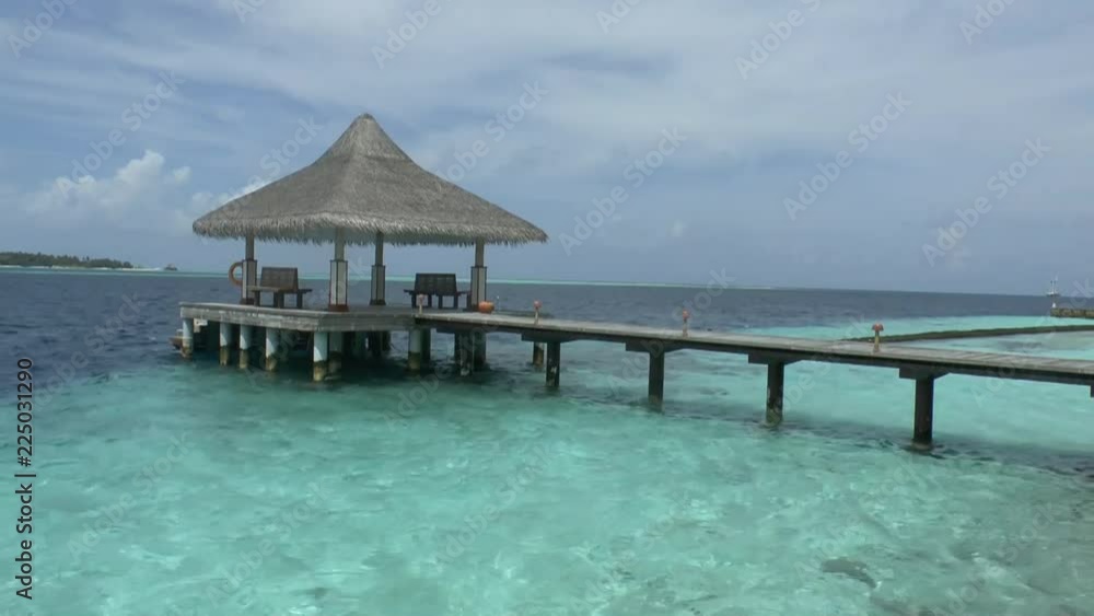 Wooden pier on a tropical beach in the Maldives Wooden pier on a tropical beach in the Maldives