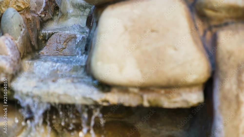 Natural spring drops fall in slow motion. Water flows dribbles and fall in drops Natural spring drops fall in slow motion. Water flows dribbles and fall in drops