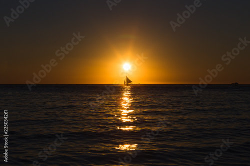 Tableau sur toile One outrigger sailboat on the horizon