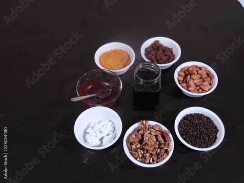 Red Paste for Joint and Knee Pain, Walnuts, Almonds,Turmeric,Black Pepper on Wooden Background