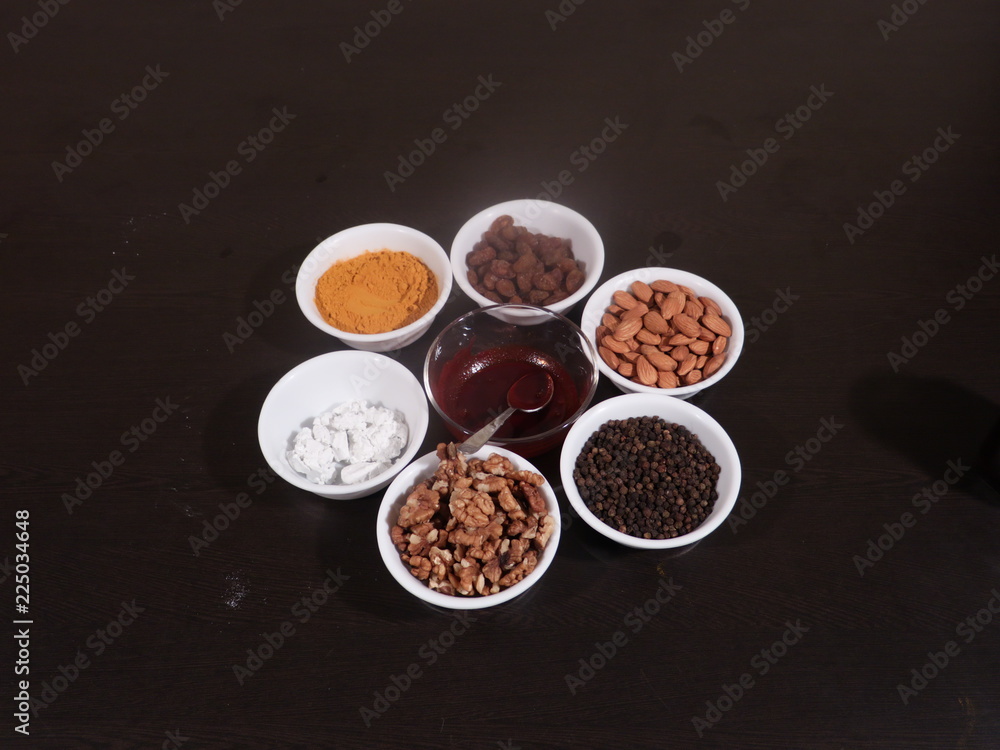 Turmeric,Limestone,Chuna,Almonds, Badam,Kali Mirch, Black Pepper,Kismish,Raisns,Haldi,Red Paste for Knee pain, Medicine for Knee Pain,Honey, Honey in Glass Jar, Wooden Background Turmeric,Limestone,Chuna,Almonds, Badam,Kali Mirch, Black Pepper,Kismish,Raisns,Haldi,Red Paste for Knee pain, Medicine for Knee Pain,Honey, Honey in Glass Jar, Wooden Background