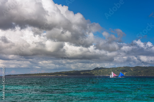 Two double outrigger sailboats on the sea photo