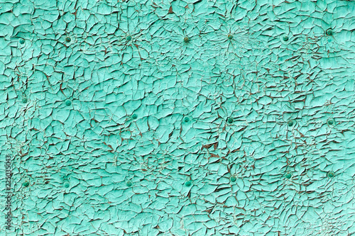 An ancient wooden background with dry peeling paint.