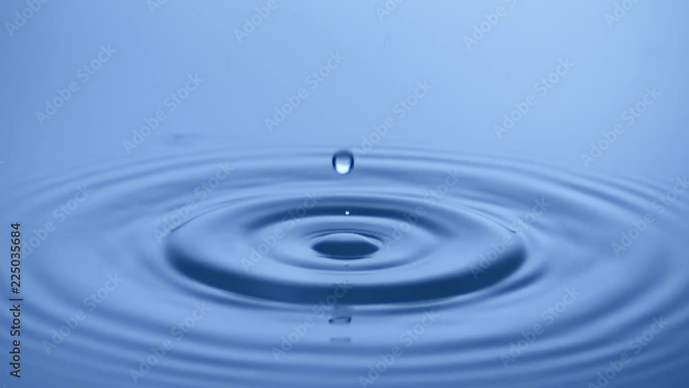 Water drop hits calm surface. See molecules physically working in slow motion Water drop hits calm surface. See molecules physically working in slow motion