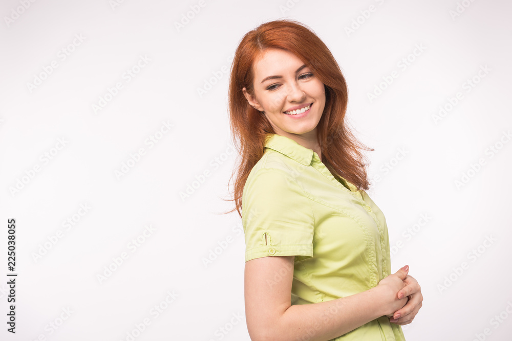Beautiful young woman with red hair on white background with copy space Beautiful young woman with red hair on white background with copy space