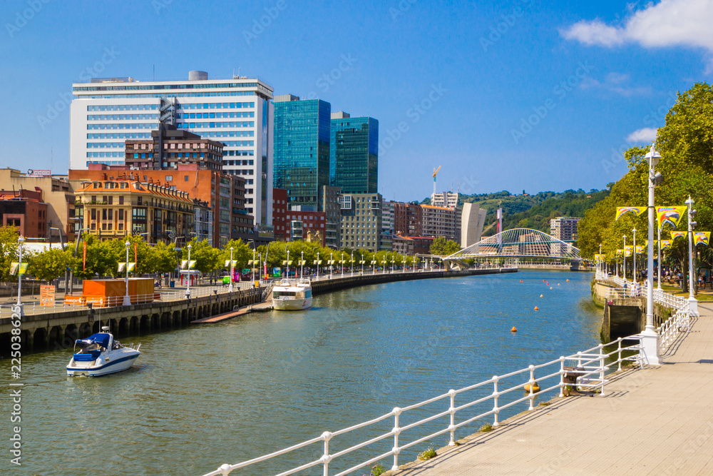 View of Bilbao, Downtown with a Nevion River, Zubizuri Bridge and promenade. Spain