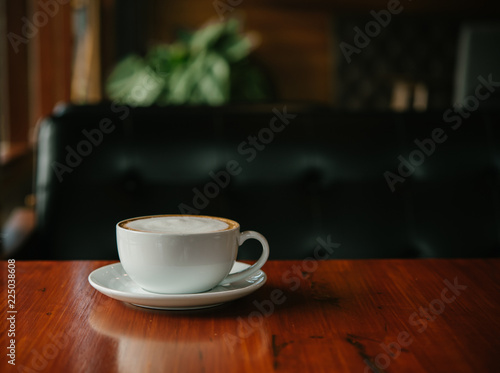 Hot Coffee in a cup on wooden table and morning light