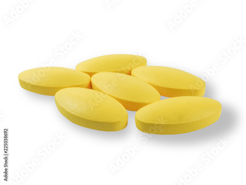 Close up of six yellow oval drugs with shadow isolated on a white background.In medicine for the treatment of disease