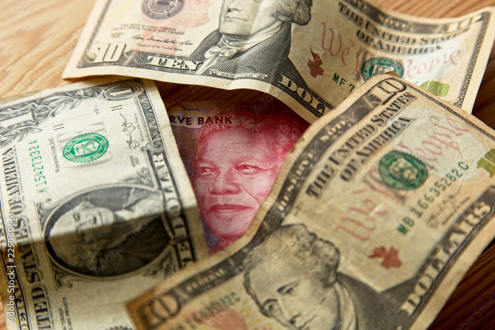 A rand to the dollar currency exchange concept image. A rand to the dollar currency exchange concept image.