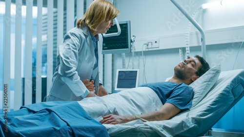 Emergency in the Hospital, Doctor Rush to Safe Dying Patient. Man is Lying on the Bed without Signs of Life. Doctor Holds Hand to Check His Heart Rate.