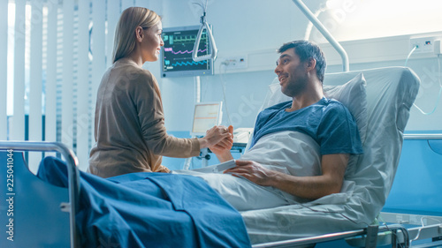 Konstfotografi In the Hospital, Man Recovering from Illness Lying in Bed, Loving Wife Visits Him