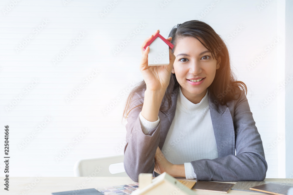 architecture, building, construction, real estate and property concept - close up of hands holding house  model.Home loan property ownership assurance concept