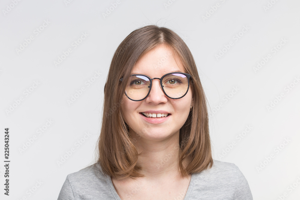 Portrait of laughing happy brown hair woman in a glasses over white background