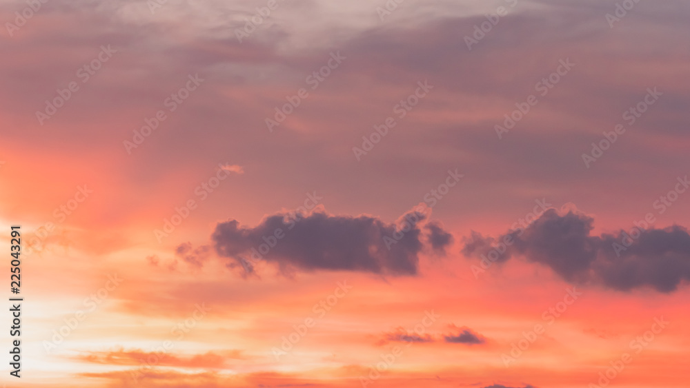 Beautiful dramatic sunset sky with orange and pink colored clouds