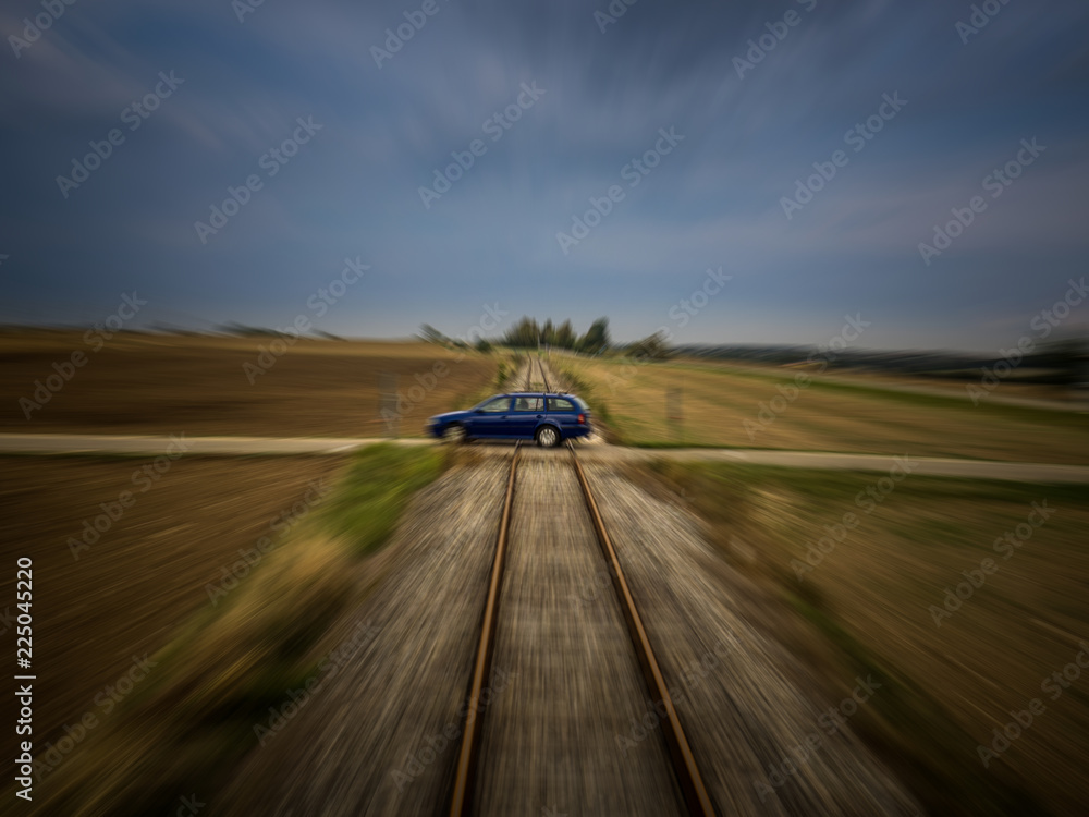 Train perspective of a car passing a railroad crossing with medium motion blur