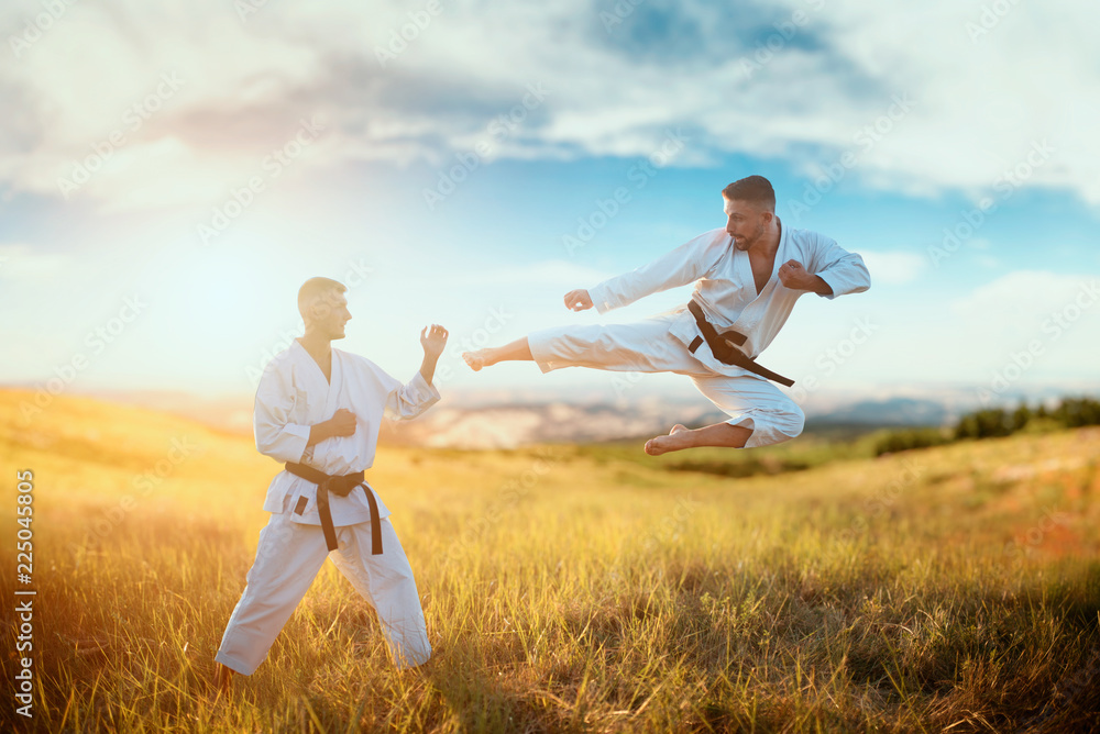 Karate fighters, kick in flight on training fight