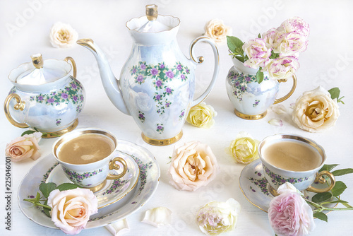 beautiful coffee set with rose flowers on white background