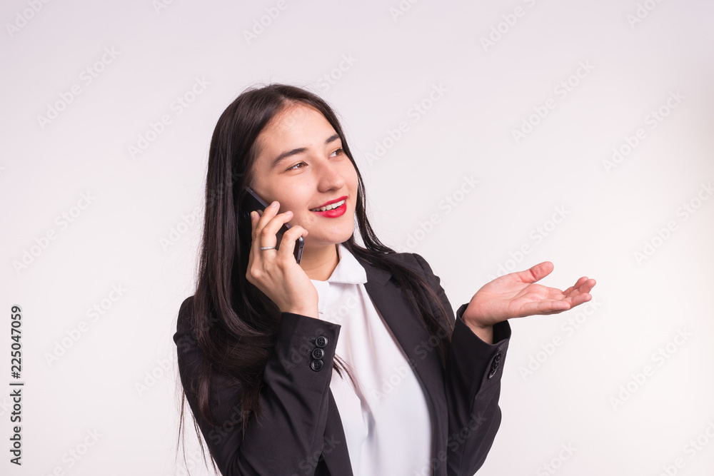 Communication and people concept - young brunette woman talking on mobile and smiling on white background Communication and people concept - young brunette woman talking on mobile and smiling on white background