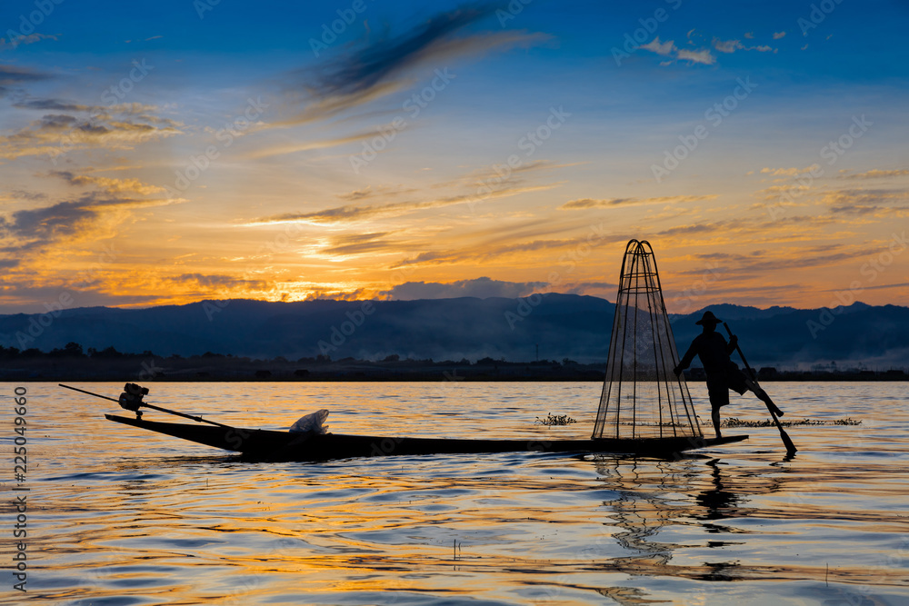 INLE LAKE, MYANMAR - DECEMBER 09, 2016 : Fisherman fishing at sunset on the Inle Lake Shan state in Myanmar (Burma)